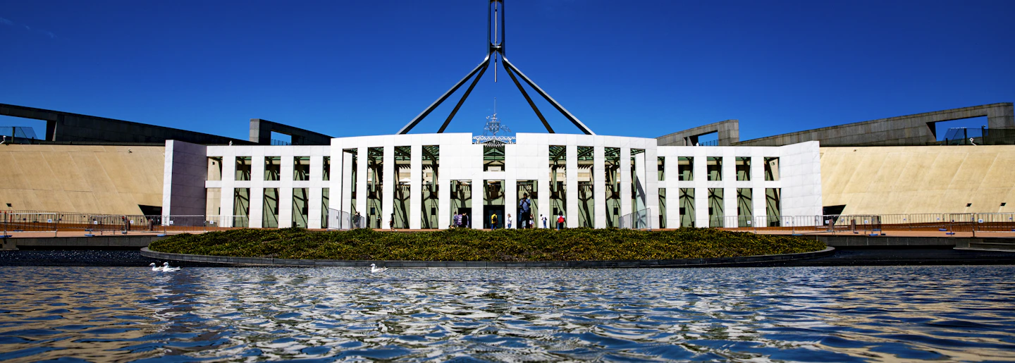 Australian Parliament House in Canberra under a clear blue sky