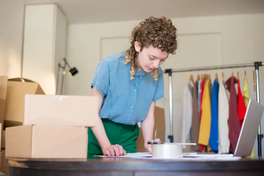 Online seller packing orders at home, where running expenses can be claimed as ecommerce business tax deductions