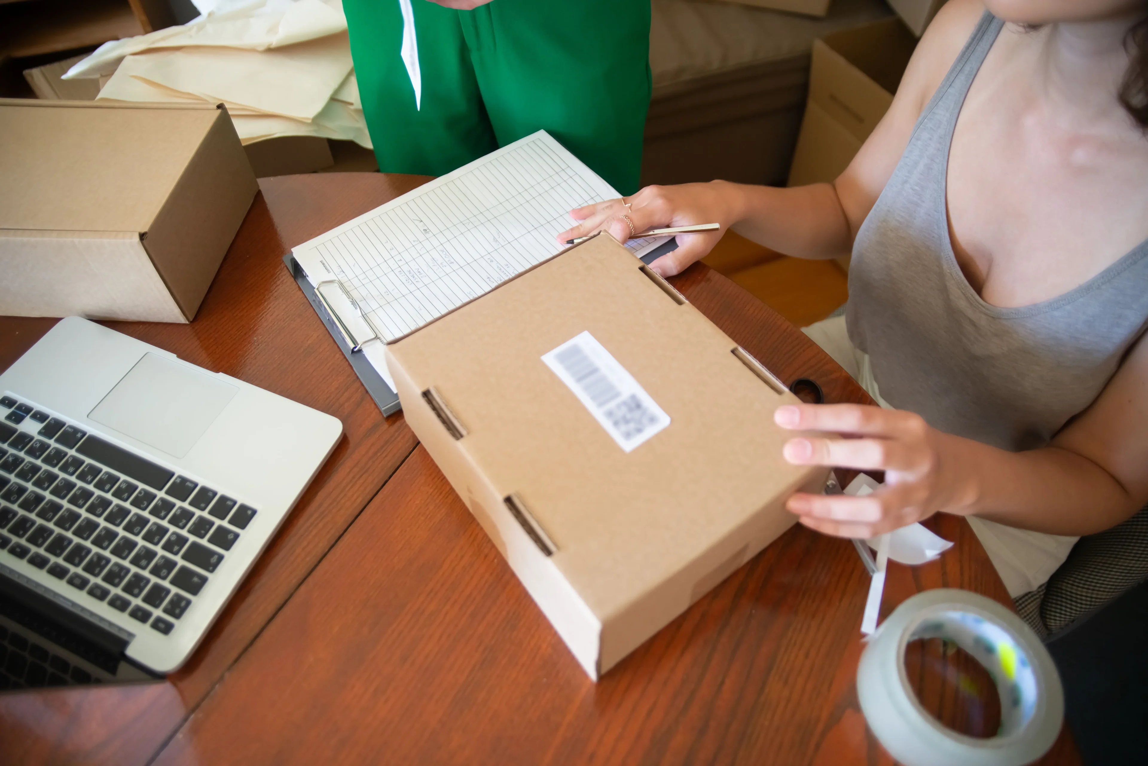 Small Business Owners Packing Online Orders, A Daily Cost Of Running An Ecommerce Business That Is Tax Deductible
